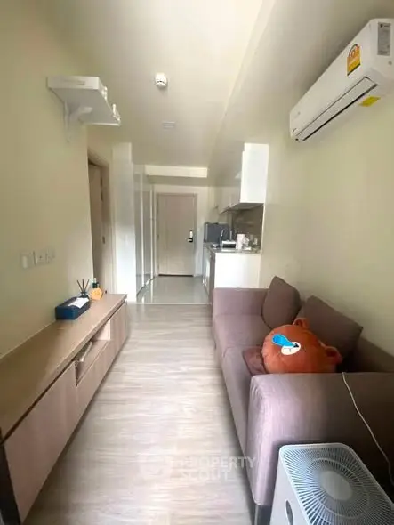 Modern living room with air conditioning and cozy sofa in a stylish apartment.