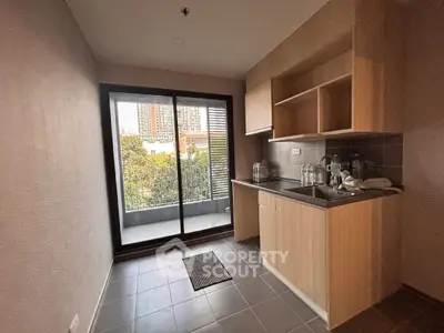 Modern kitchen with balcony view in urban apartment