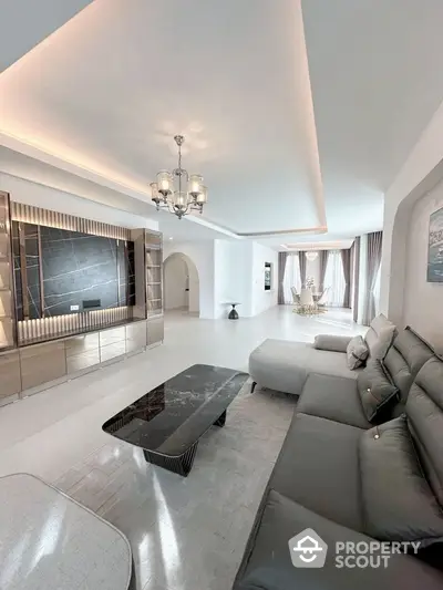 Luxurious modern living room with elegant chandelier and spacious seating area