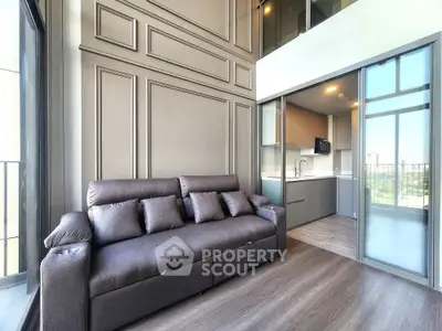 Modern living room with sleek design and open kitchen layout