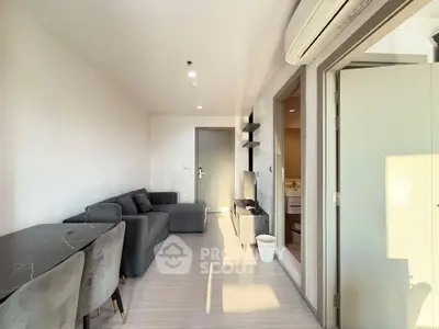 Modern living room with sleek gray furniture and abundant natural light