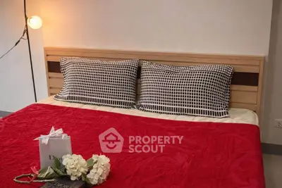 Cozy bedroom with stylish bedding and soft lighting, perfect for relaxation.