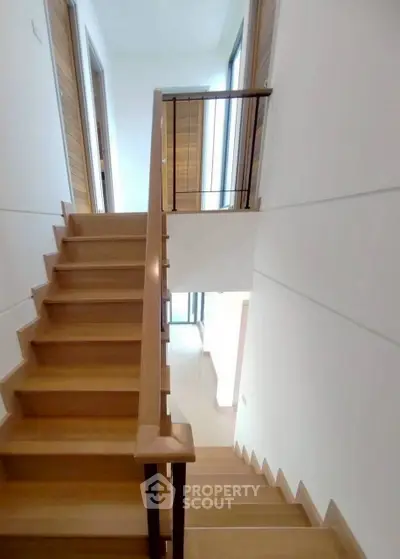 Modern wooden staircase with sleek design in a contemporary home interior