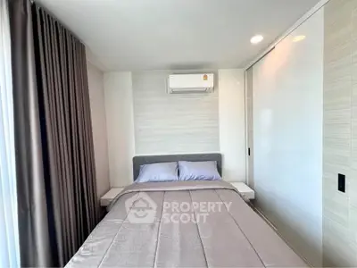 Cozy bedroom with modern air conditioning and elegant curtains in a stylish apartment.
