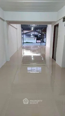 Spacious open-plan interior with glossy tiled flooring and ample natural light, ideal for versatile use.