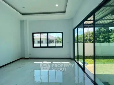Spacious modern living room with large windows and garden view