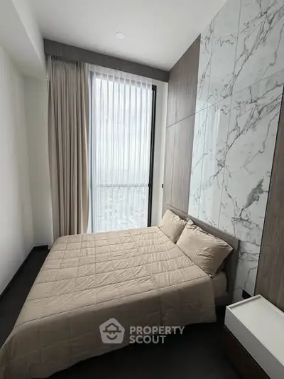 Modern bedroom with marble accent wall and large window view