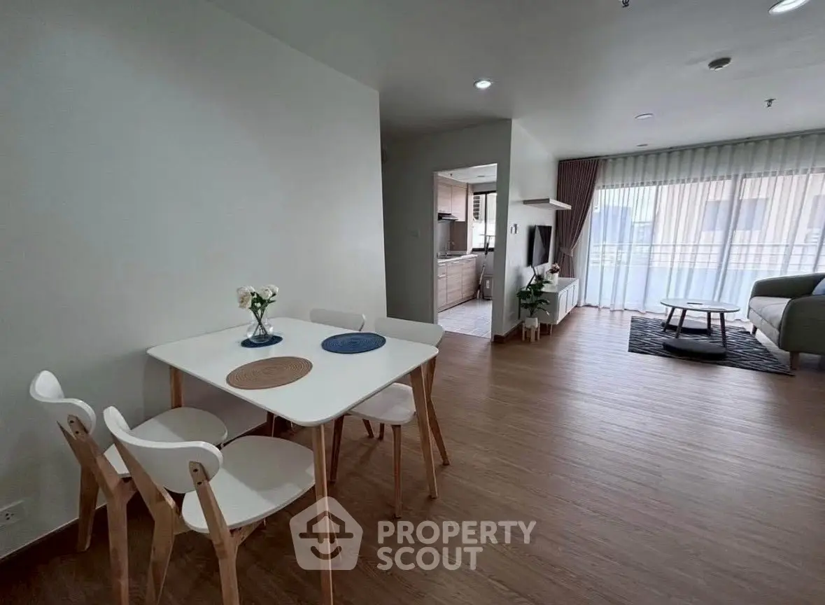 Modern open-plan living room with dining area and large windows