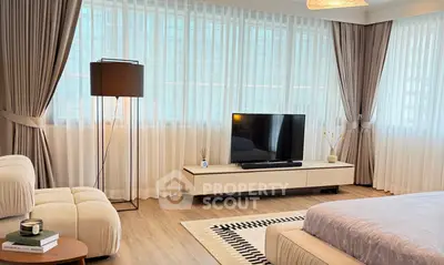 Spacious modern living room with large windows and elegant decor