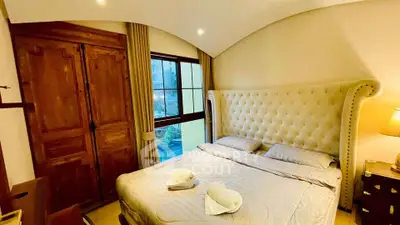 Luxurious bedroom with elegant decor and large window view