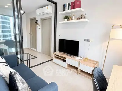 Modern living room with sleek furniture and wall-mounted TV in a stylish apartment.