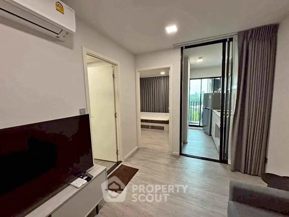 Modern apartment interior with living room, bedroom, and balcony view.