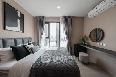 Modern bedroom with stylish decor and city view, featuring a cozy bed and elegant furnishings.