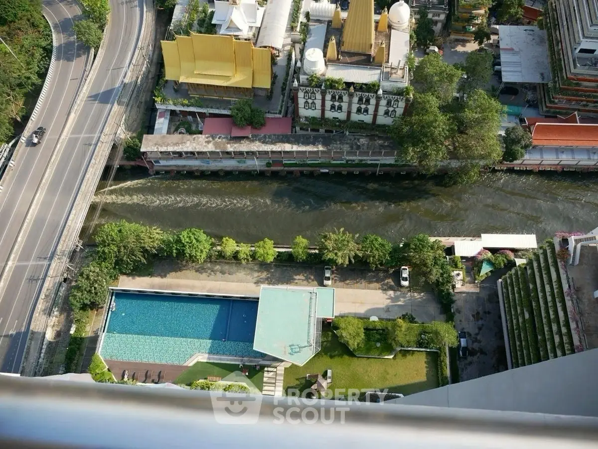 Stunning aerial view of urban landscape with pool and river, perfect for city living.