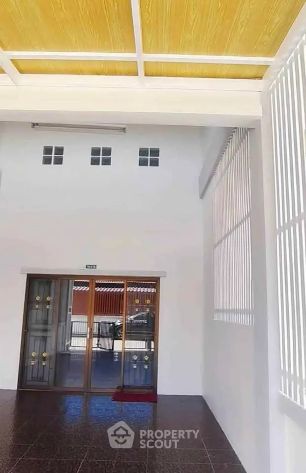 Spacious entrance with modern sliding doors and high ceiling, perfect for welcoming guests.