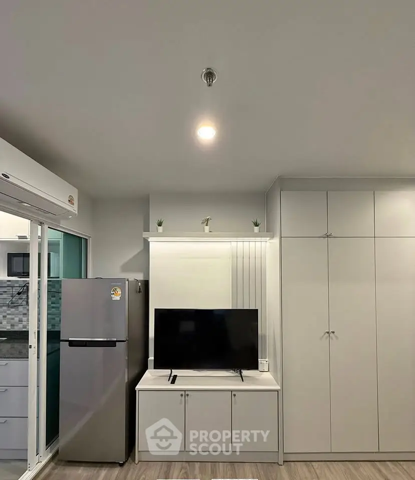 Modern living room with sleek TV unit and spacious storage cabinets