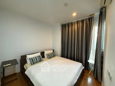 Modern bedroom with cozy bed and stylish curtains in a well-lit apartment.