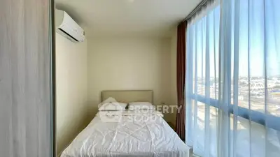 Bright bedroom with large window and air conditioning in modern apartment