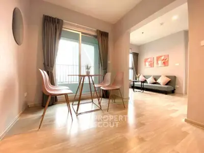 Modern apartment with open layout, featuring stylish dining area and cozy living room with natural light.