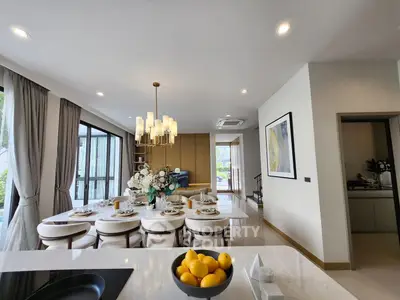Luxurious open-plan living and dining area with elegant decor and natural light.