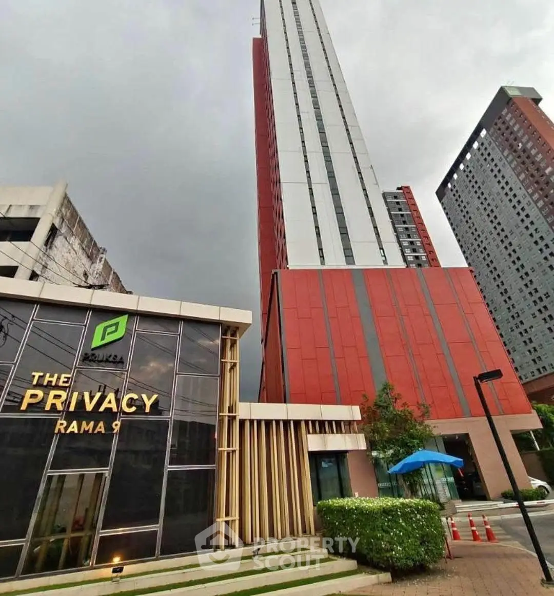 Modern high-rise building with sleek design at The Privacy Rama 9, showcasing urban living in Bangkok.