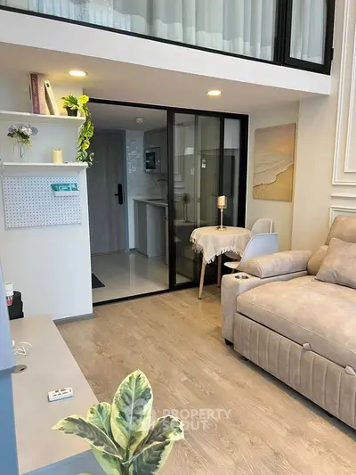 Modern living room with cozy sofa and stylish decor in open-plan apartment