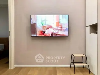 Modern living room with wall-mounted TV and minimalist decor