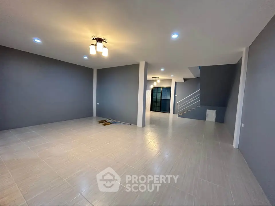Spacious modern living room with sleek tile flooring and contemporary lighting