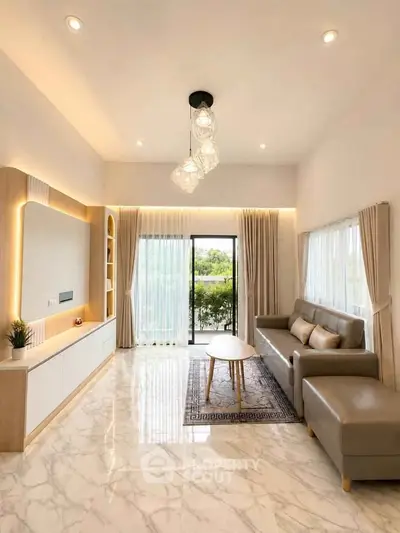 Elegant living room with modern decor, large windows, and stylish lighting.