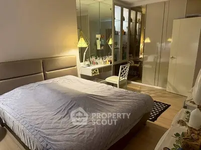 Spacious bedroom with mirrored wardrobe and elegant decor