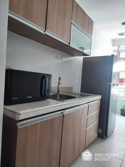 Modern kitchen with sleek wooden cabinets and stainless steel appliances