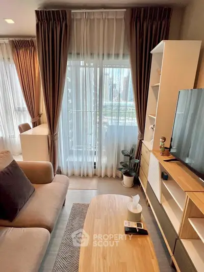 Modern living room with stylish furniture and large windows offering city views.