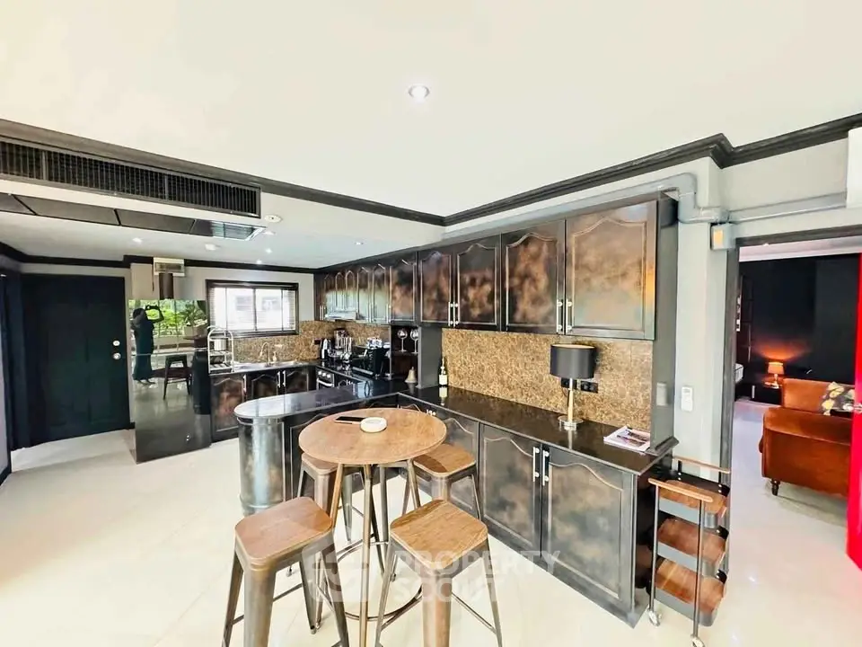 Modern kitchen with sleek cabinetry and bar seating in a stylish open layout apartment.