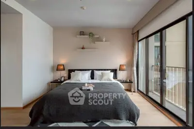 Luxurious bedroom with modern decor and large windows offering natural light