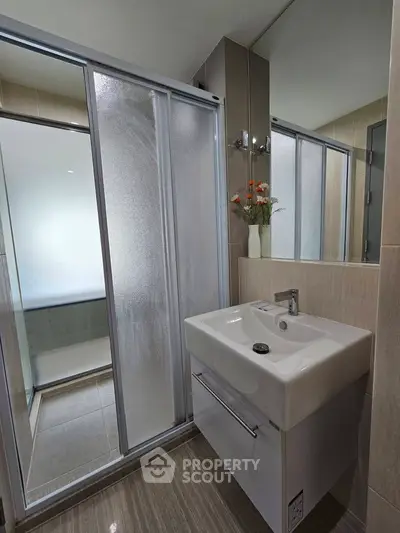 Modern bathroom with sleek sink and sliding glass shower doors