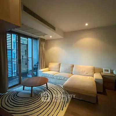 Cozy living room with modern sofa and stylish rug, featuring a balcony view.