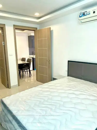 Modern bedroom with air conditioning and view into dining area, showcasing sleek design and comfort.