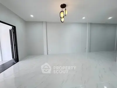 Spacious modern living room with elegant lighting and sleek white flooring