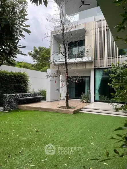 Modern luxury home with spacious garden and sleek architectural design