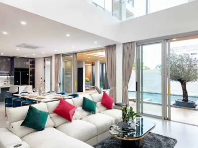Luxurious open-plan living room with pool view and modern decor