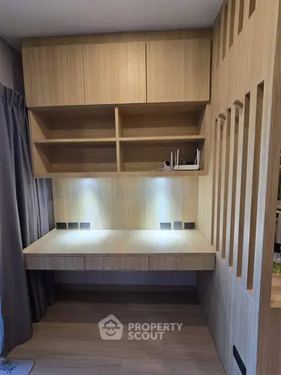 Modern study room with built-in wooden desk and shelves, perfect for home office setup.