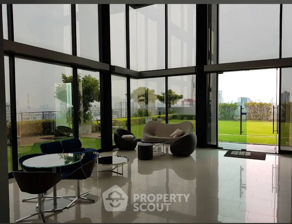 Luxurious modern living room with floor-to-ceiling windows and stunning garden view.