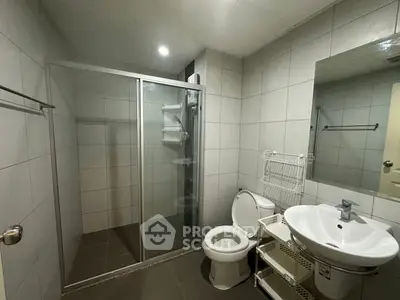 Modern bathroom with glass shower and sleek fixtures in a contemporary home.
