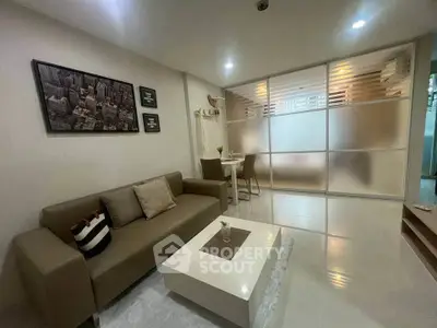 Modern living room with stylish decor and frosted glass partition in a cozy apartment.