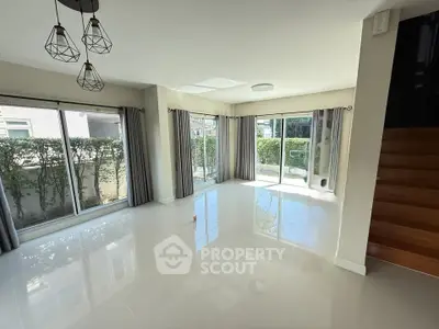 Spacious modern living room with large windows and garden view