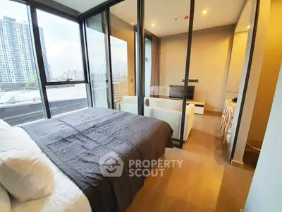 Modern bedroom with glass walls and city view in luxury apartment