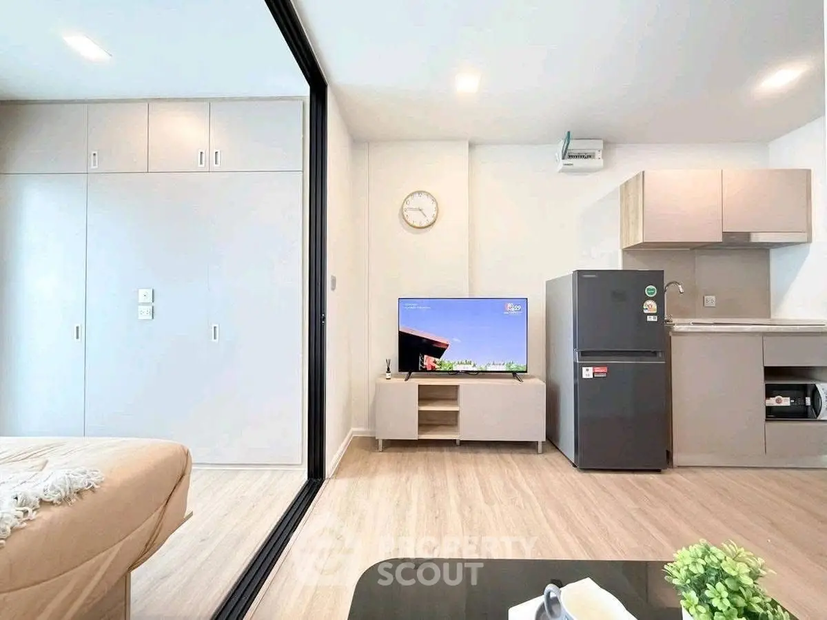 Modern open-plan living room with sleek kitchen and stylish decor