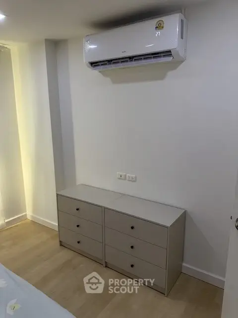 Modern bedroom with sleek air conditioning and minimalist dresser