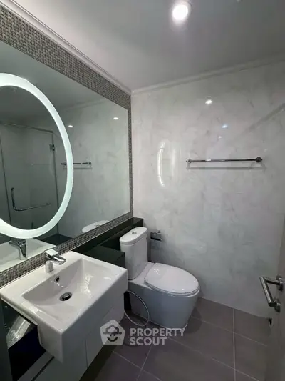 Modern bathroom with elegant fixtures and illuminated mirror