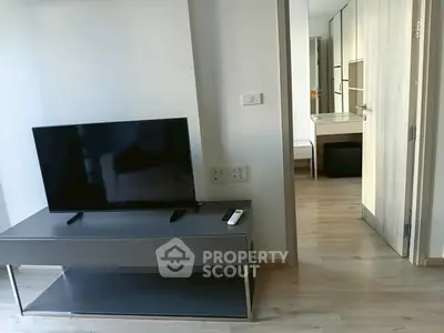 Modern apartment interior with sleek TV stand and hallway view, showcasing minimalist design and functionality.